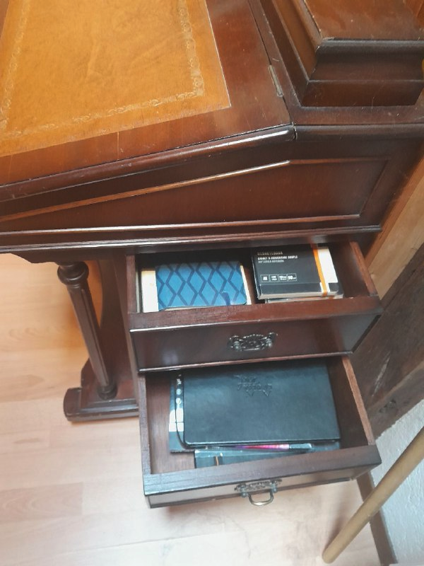 les deux premiers tiroirs sur le flanc droit du Davenport sont ouverts et laissent voir une opulente collection de petits carnets lignés dans le premier, puis dans le second, de plus grands carnets à vélin spécialisé : calligraphie, aquarelle, papier à points, papier noir...